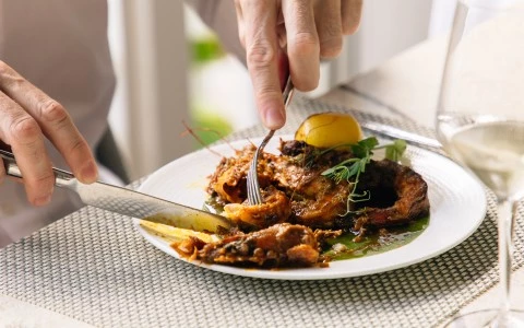 a person eating food on a plate