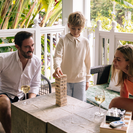 a man, woman, and child playing Jenga