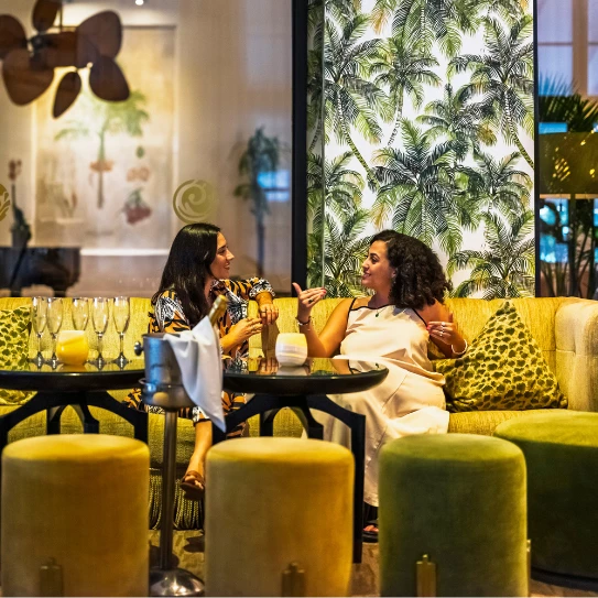 two women sitting on a couch