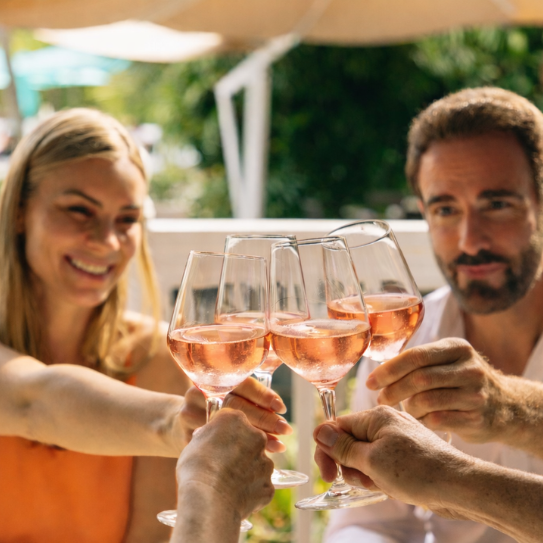 a group of people clinking wine glasses