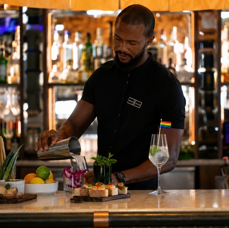 a man pouring a drink into a glass