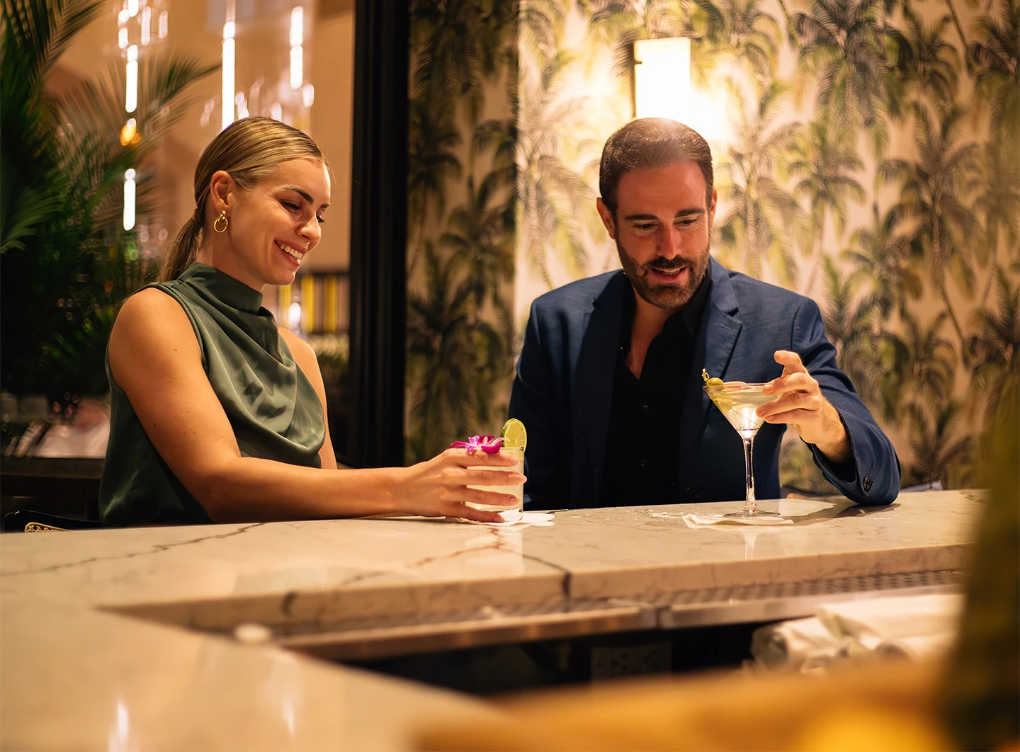 a man and woman sitting at a bar