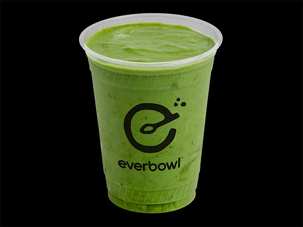 a green smoothie in a plastic cup