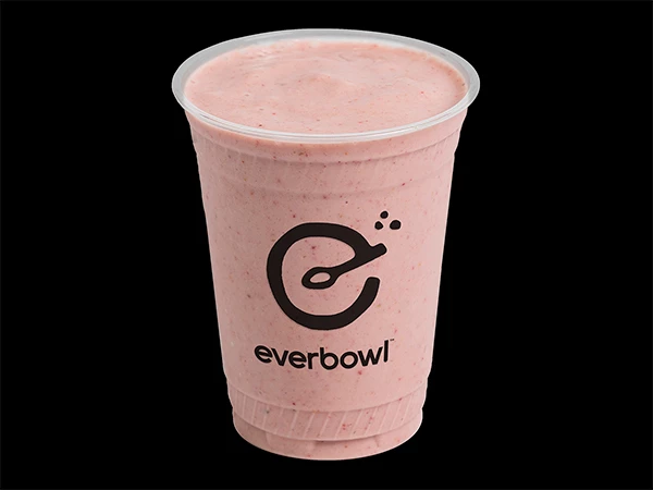 a plastic cup with a pink liquid in it