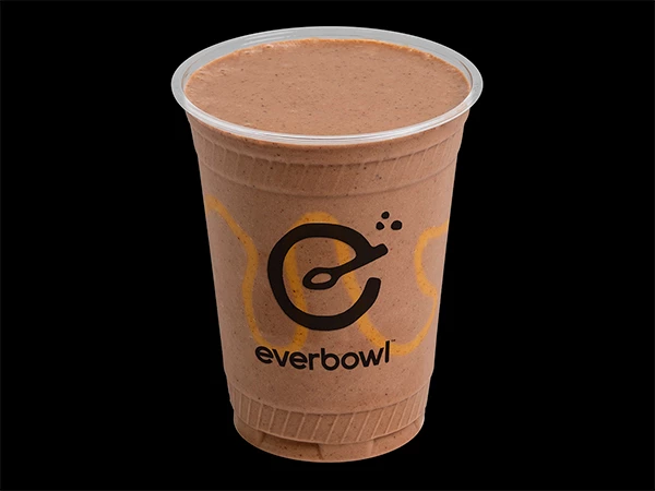 a brown beverage in a plastic cup