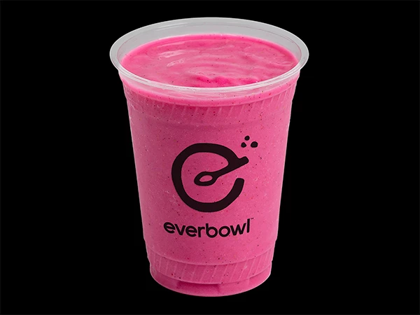 a plastic cup with a pink liquid in it
