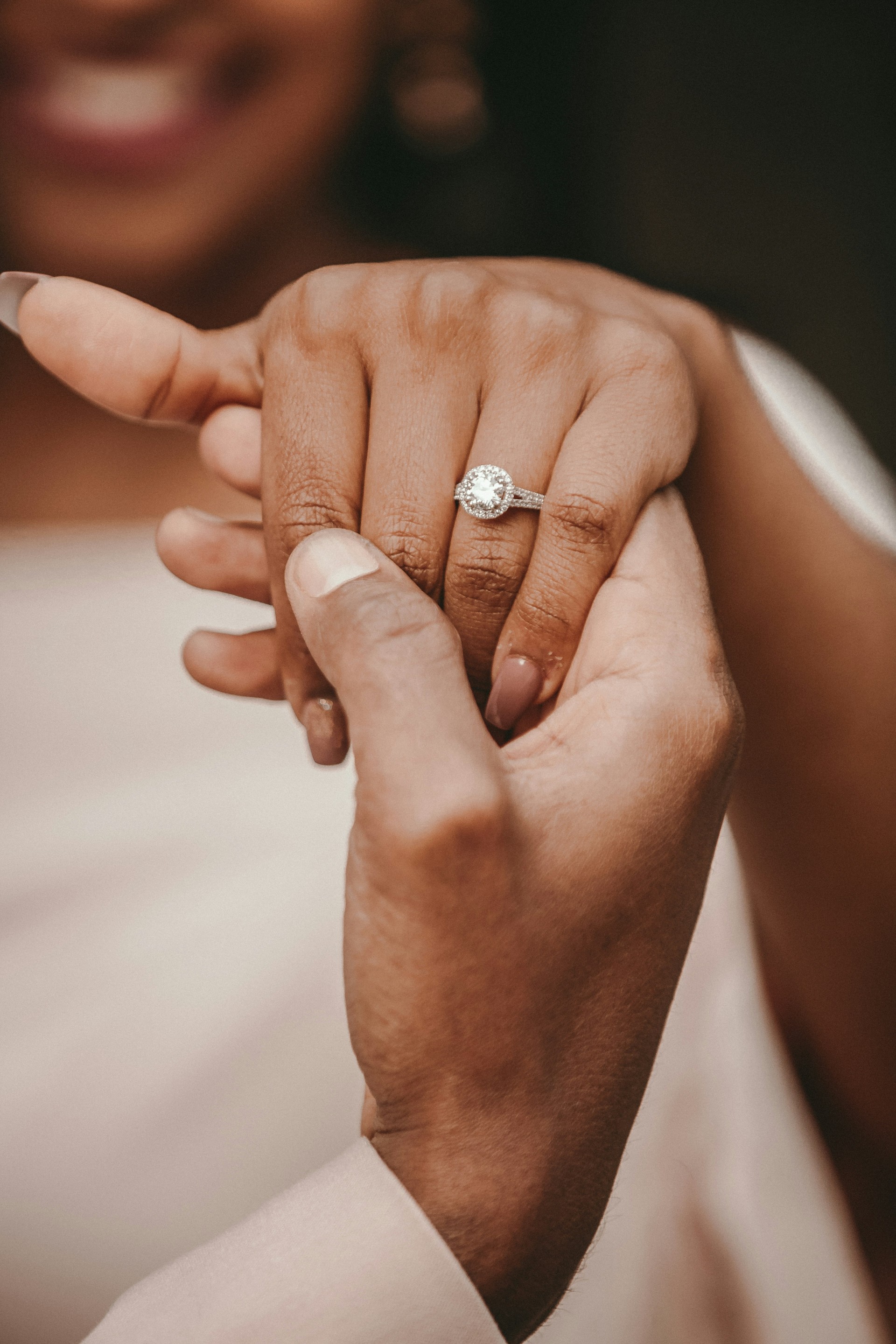 a close up of a hand holding a ring