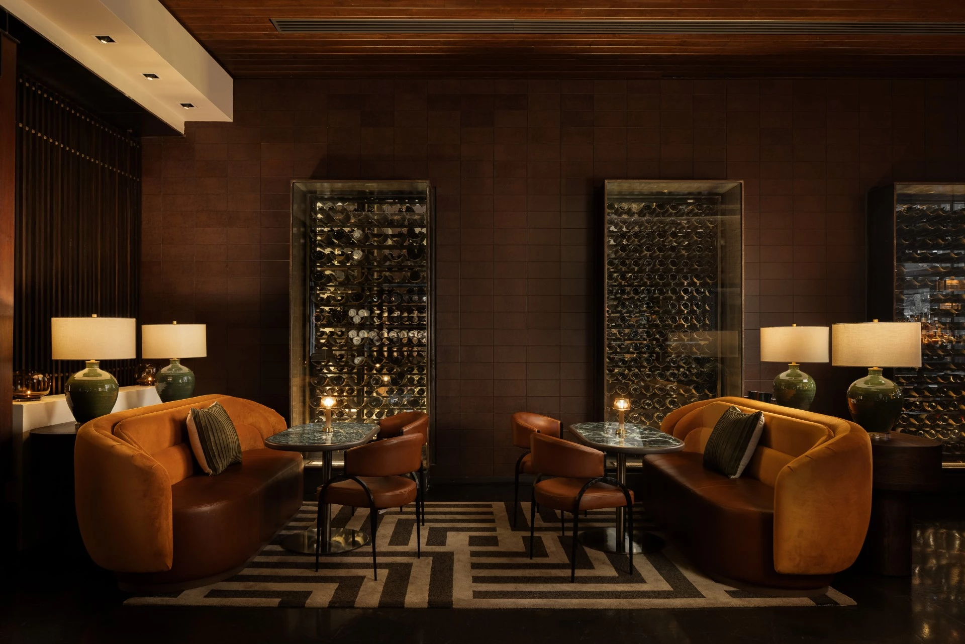 a room with a wine rack and couches