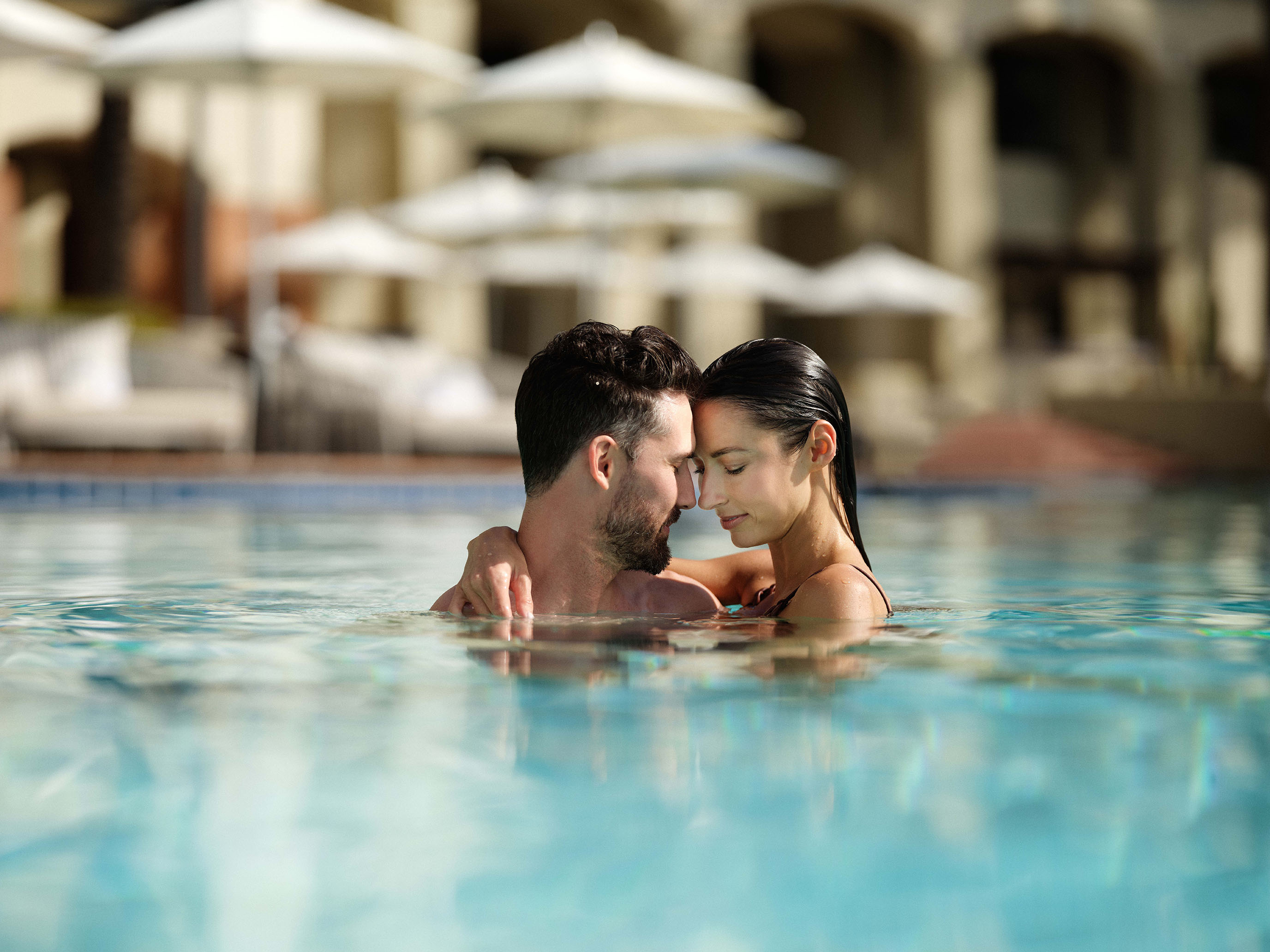 a man and woman in a pool