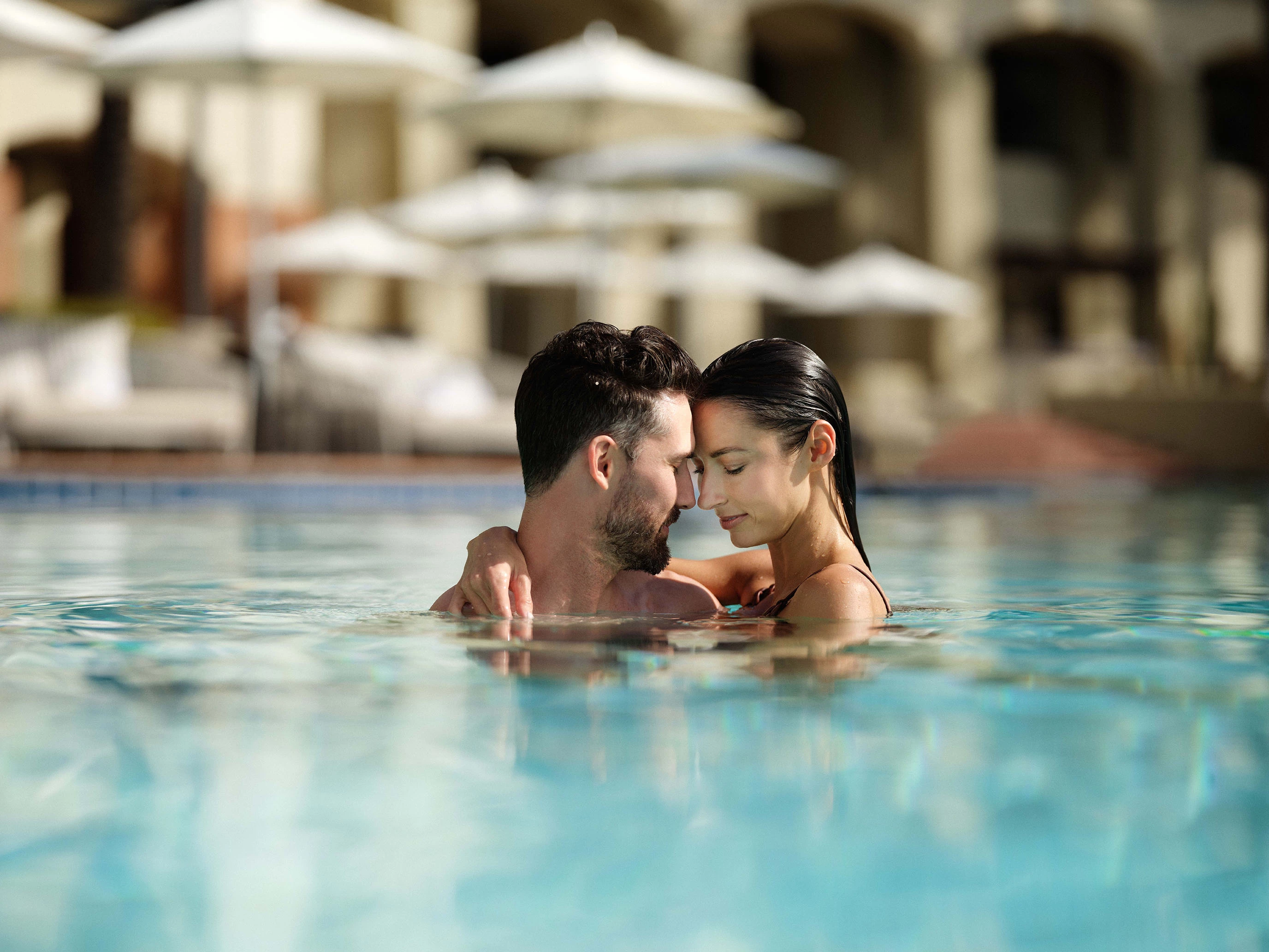 a man and woman in a pool