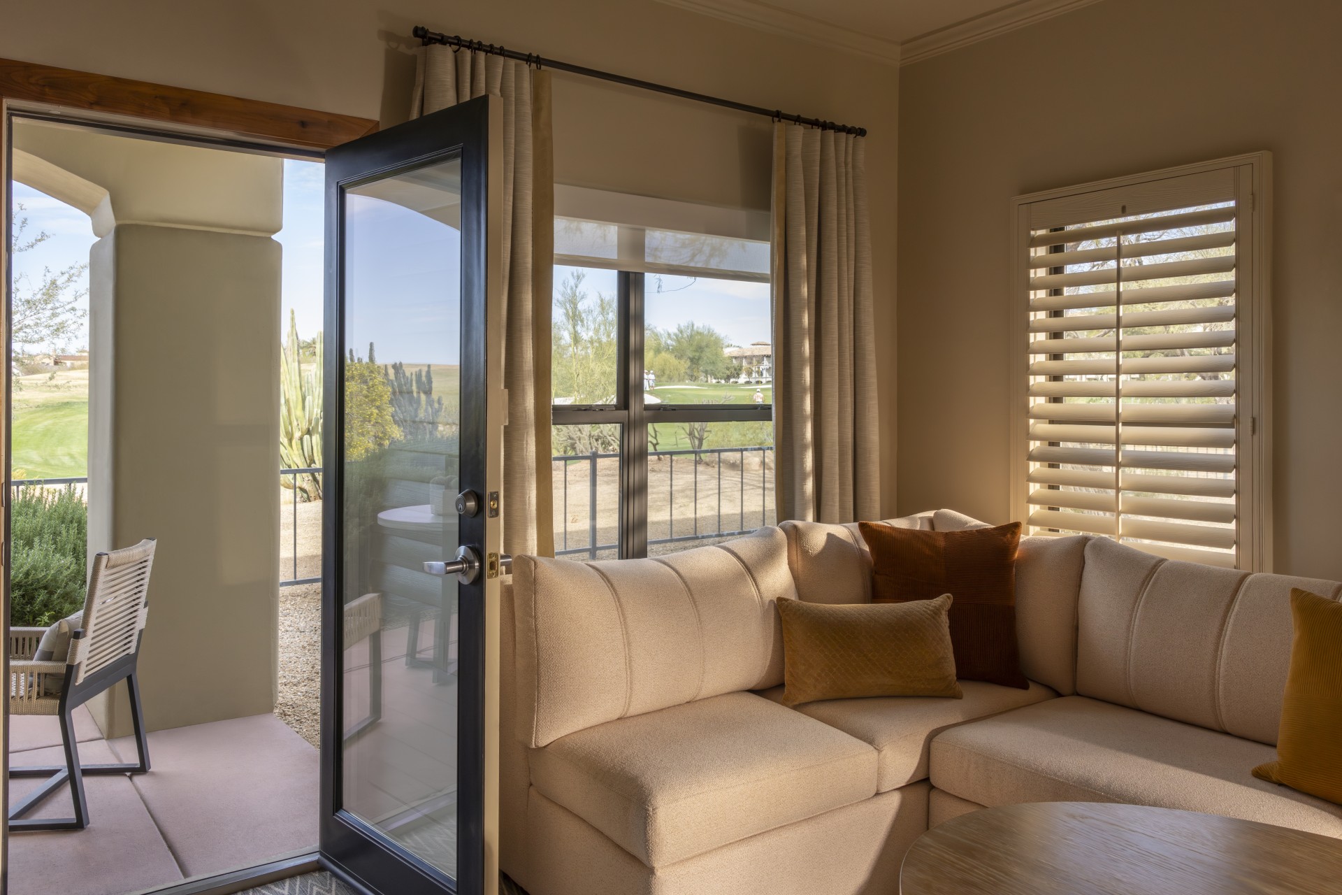 a living room with a couch and a glass door