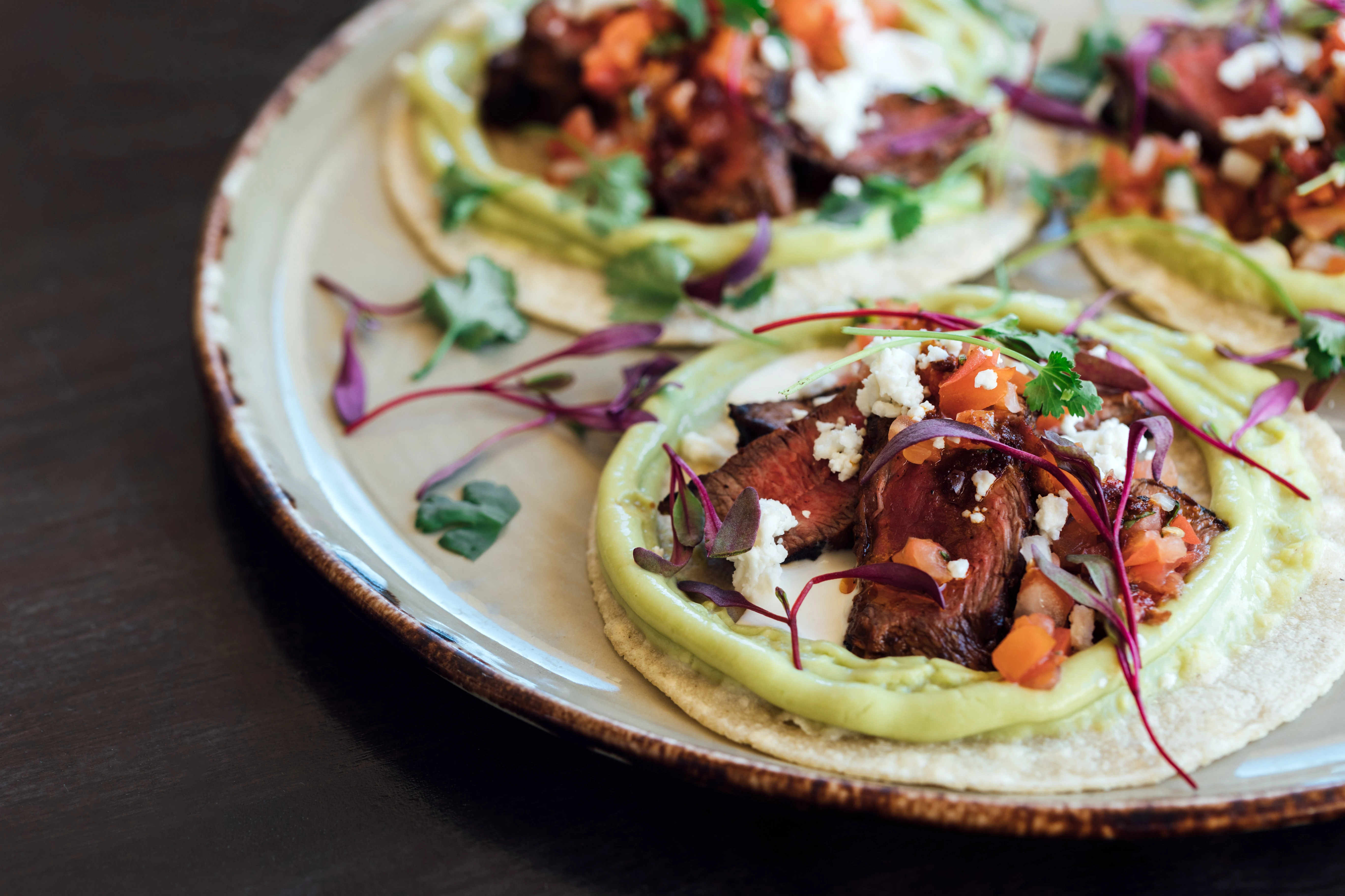 a plate of tacos with meat and vegetables