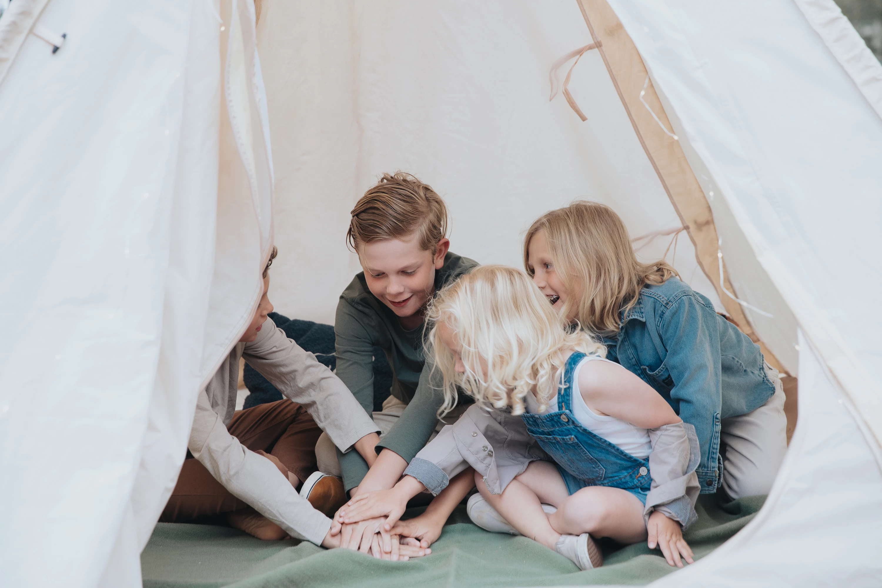 a group of kids sitting in a tent