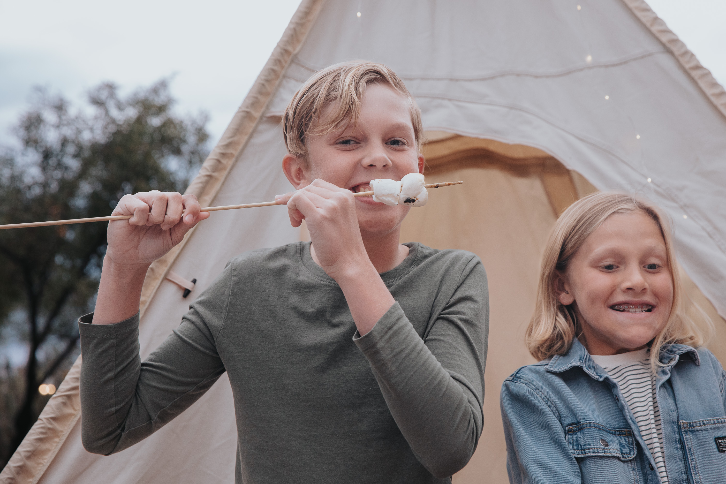 a boy and girl eating marshmallows