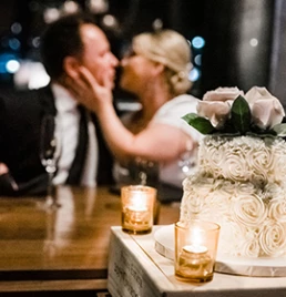 a cake with roses and candles on a table