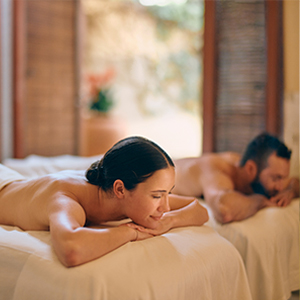 a man and woman lying on a bed