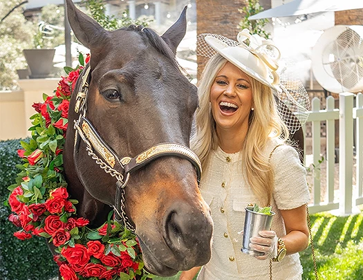 a woman standing next to a horse