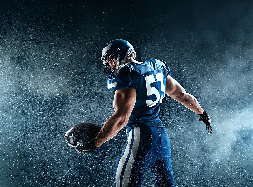 a football player holding a ball