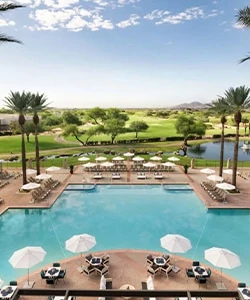 a pool with umbrellas and chairs