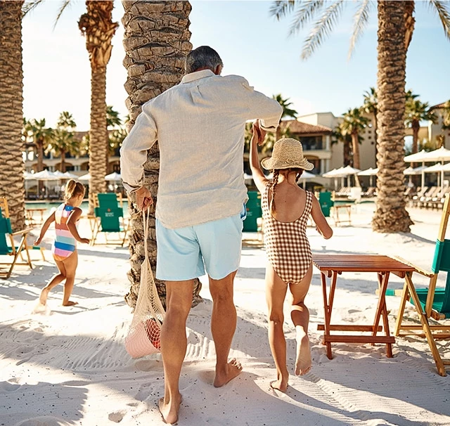 a man and woman walking on a beach