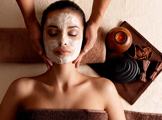 a woman receiving a facial massage
