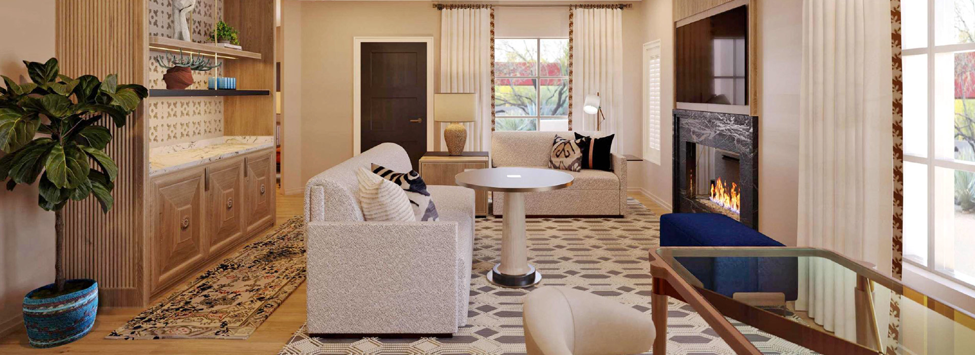 a living area with couches and a lit fireplace with lots of sunlight coming in from outside