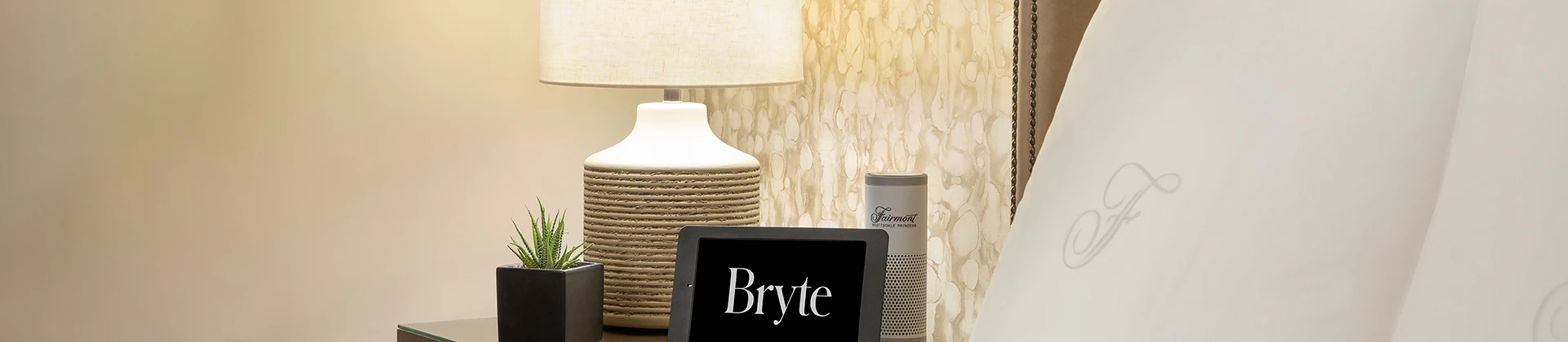 close up of the nightstand with alarm clock and speaker on it