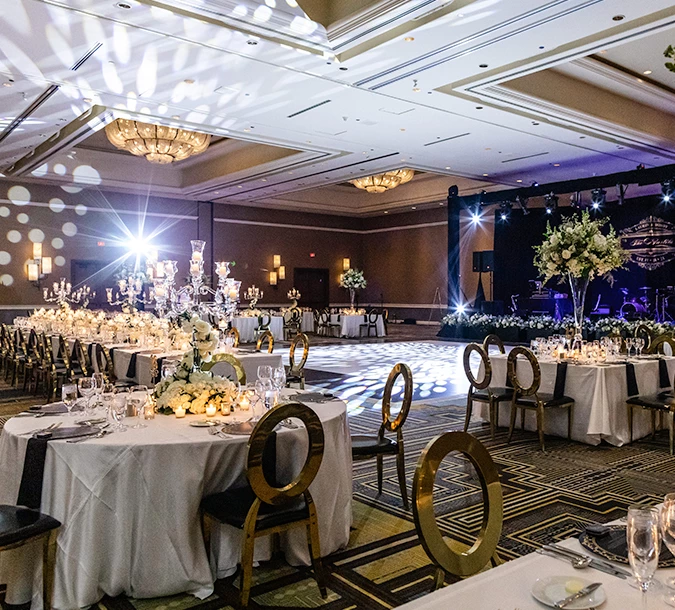 a large room with a dance floor and tables for dining