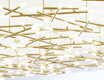 A modern chandelier made from several connecting golden-colored rods