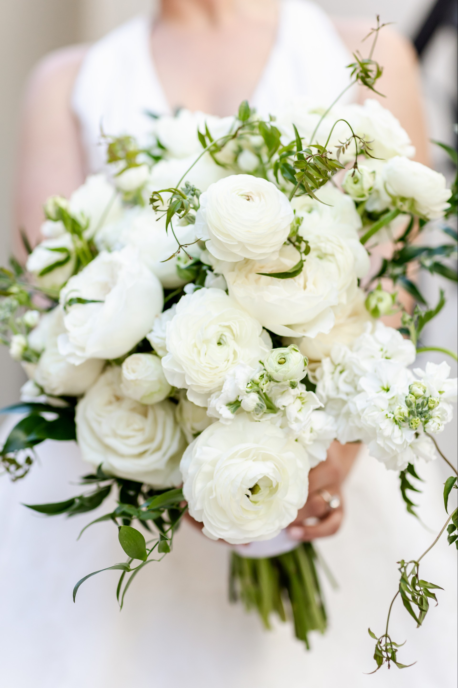 a person holding a bouquet of white flowers