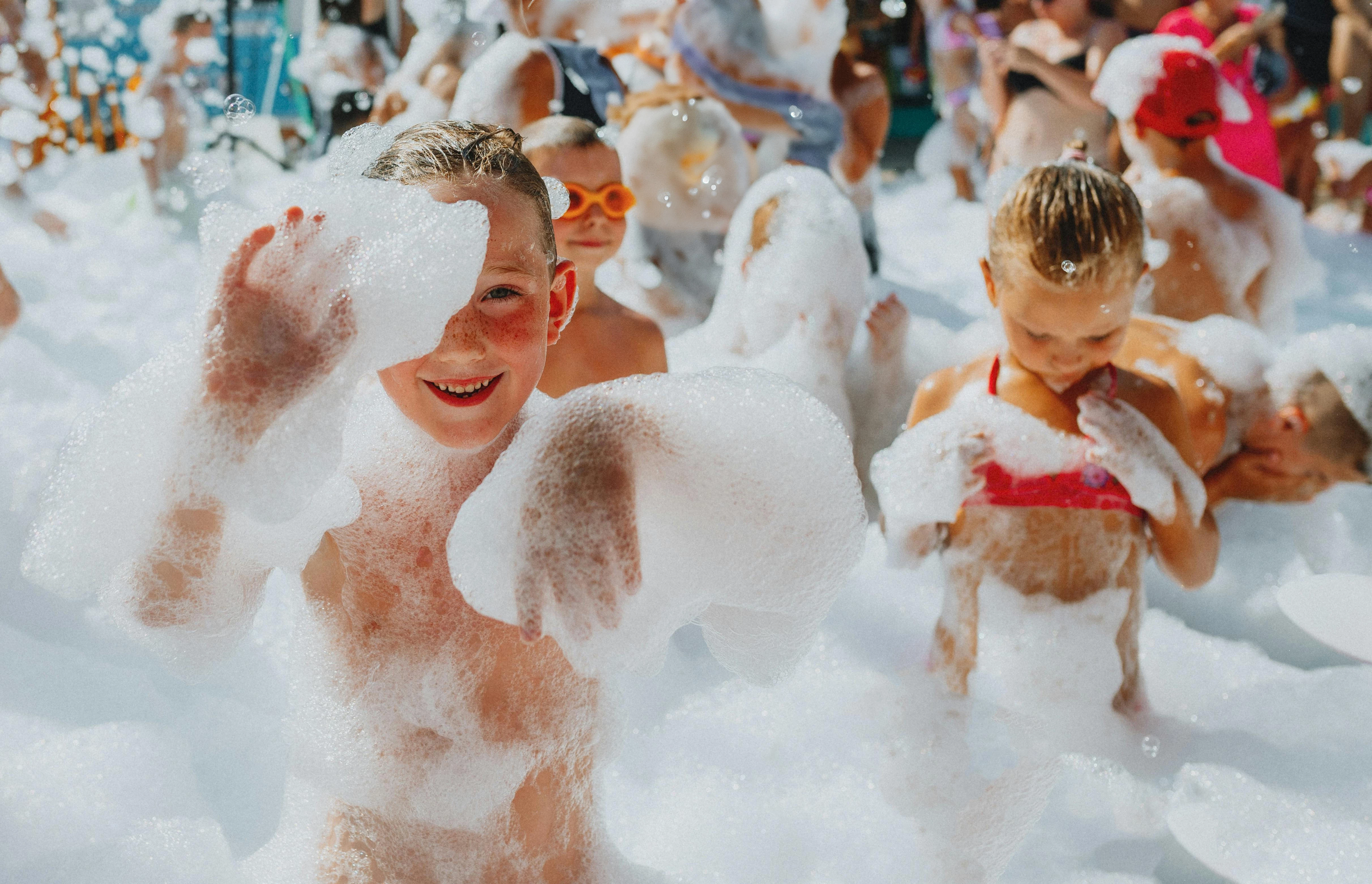 a group of children in a foamy pool