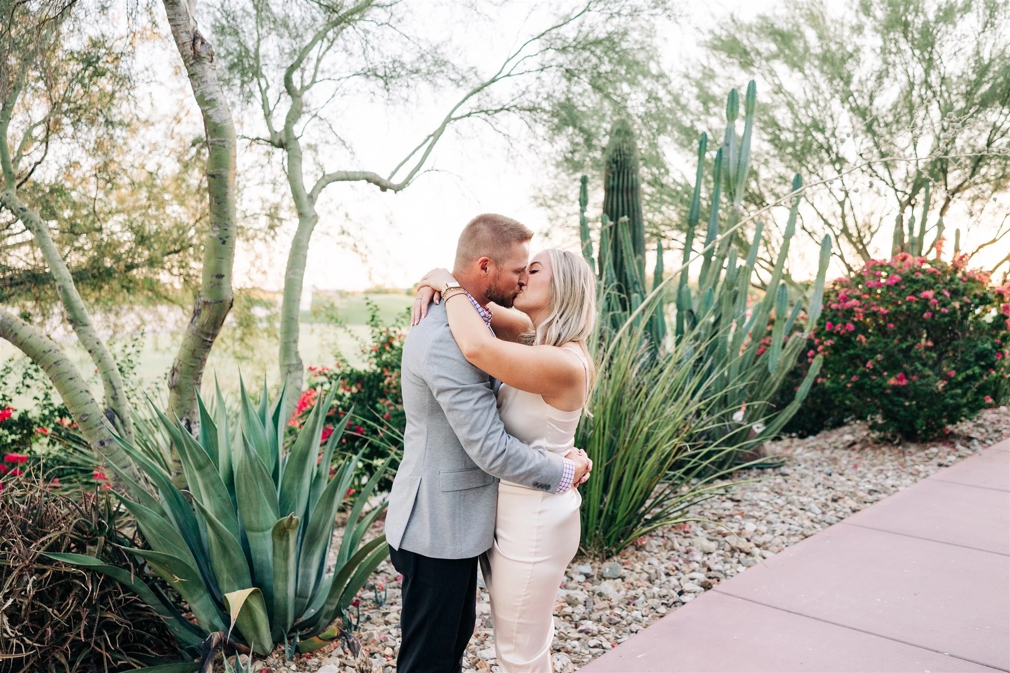 a man and woman kissing outside