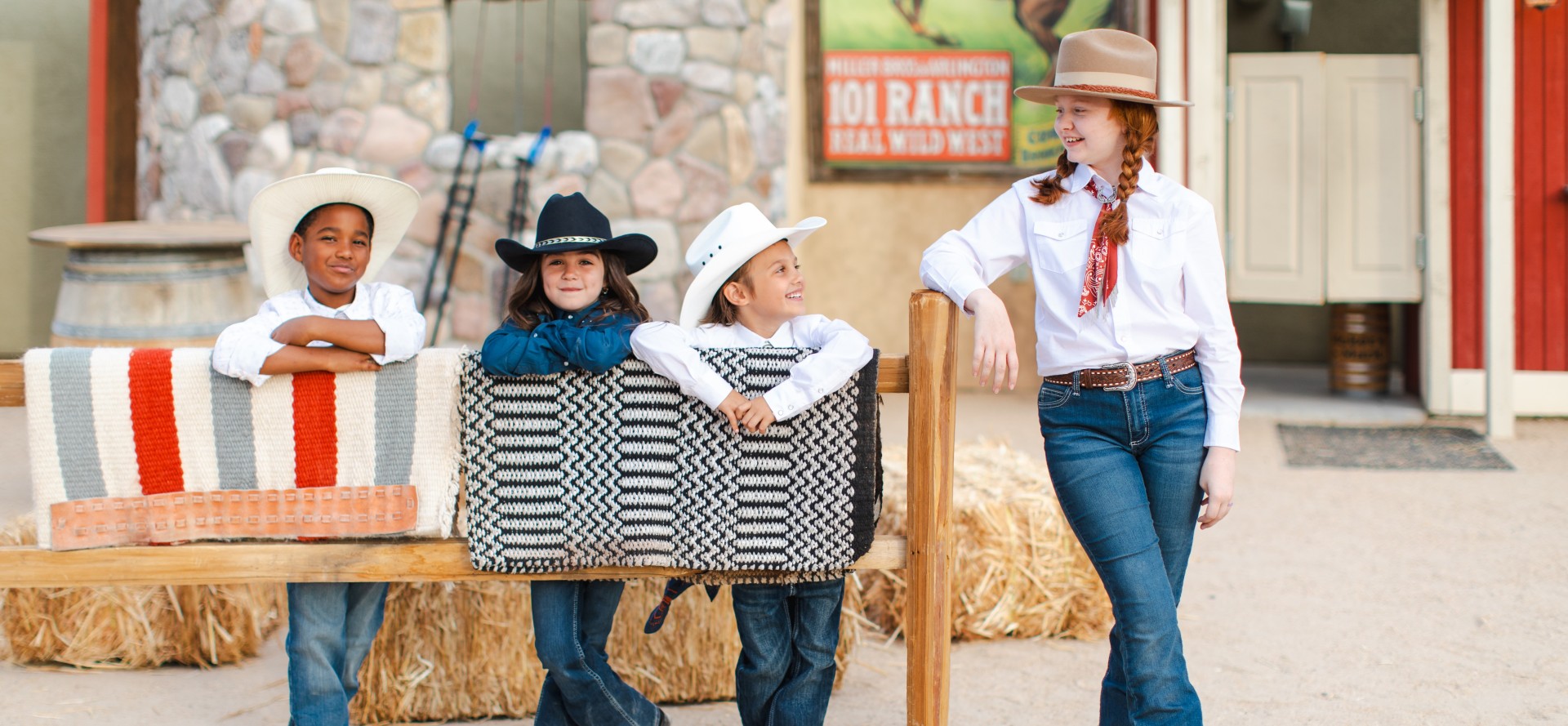 a group of kids in cowboy hats