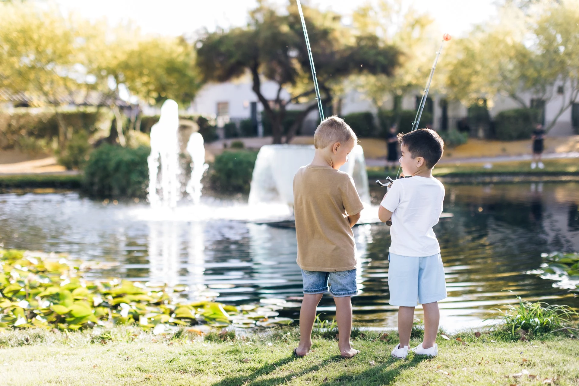 two boys standing in front of a fountain
