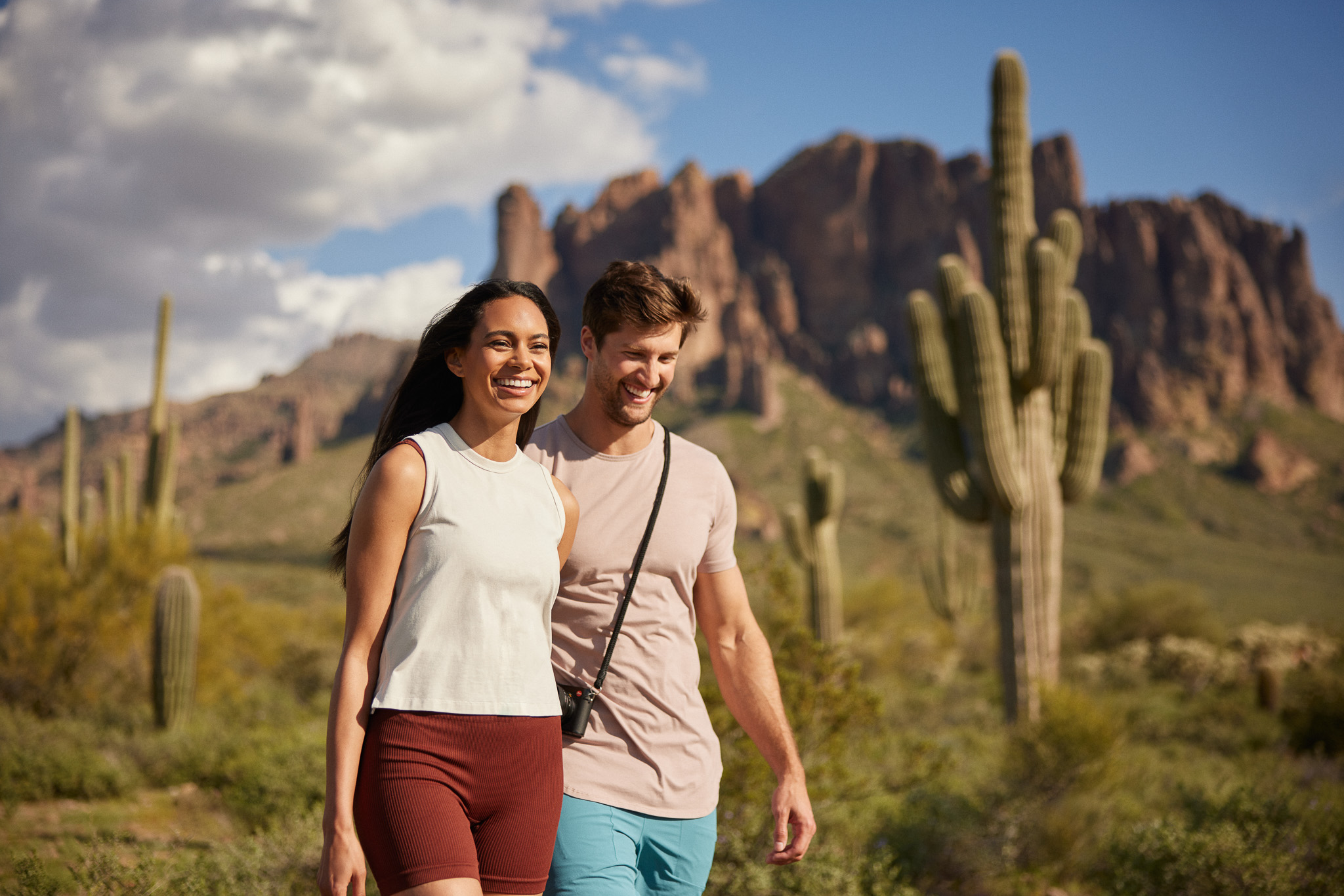 a man and woman posing for a picture in front of a mountain