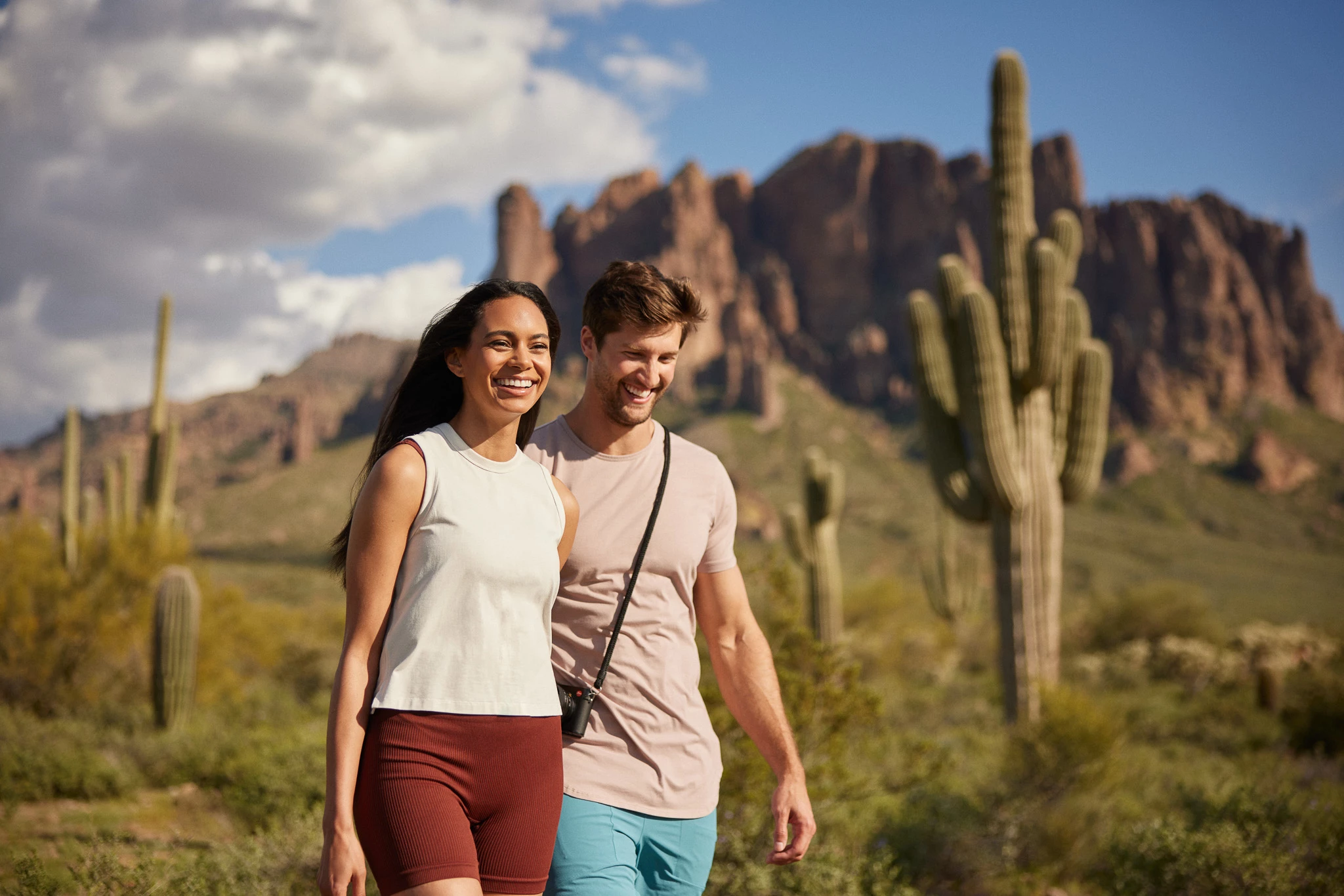 a man and woman posing for a picture in front of a mountain