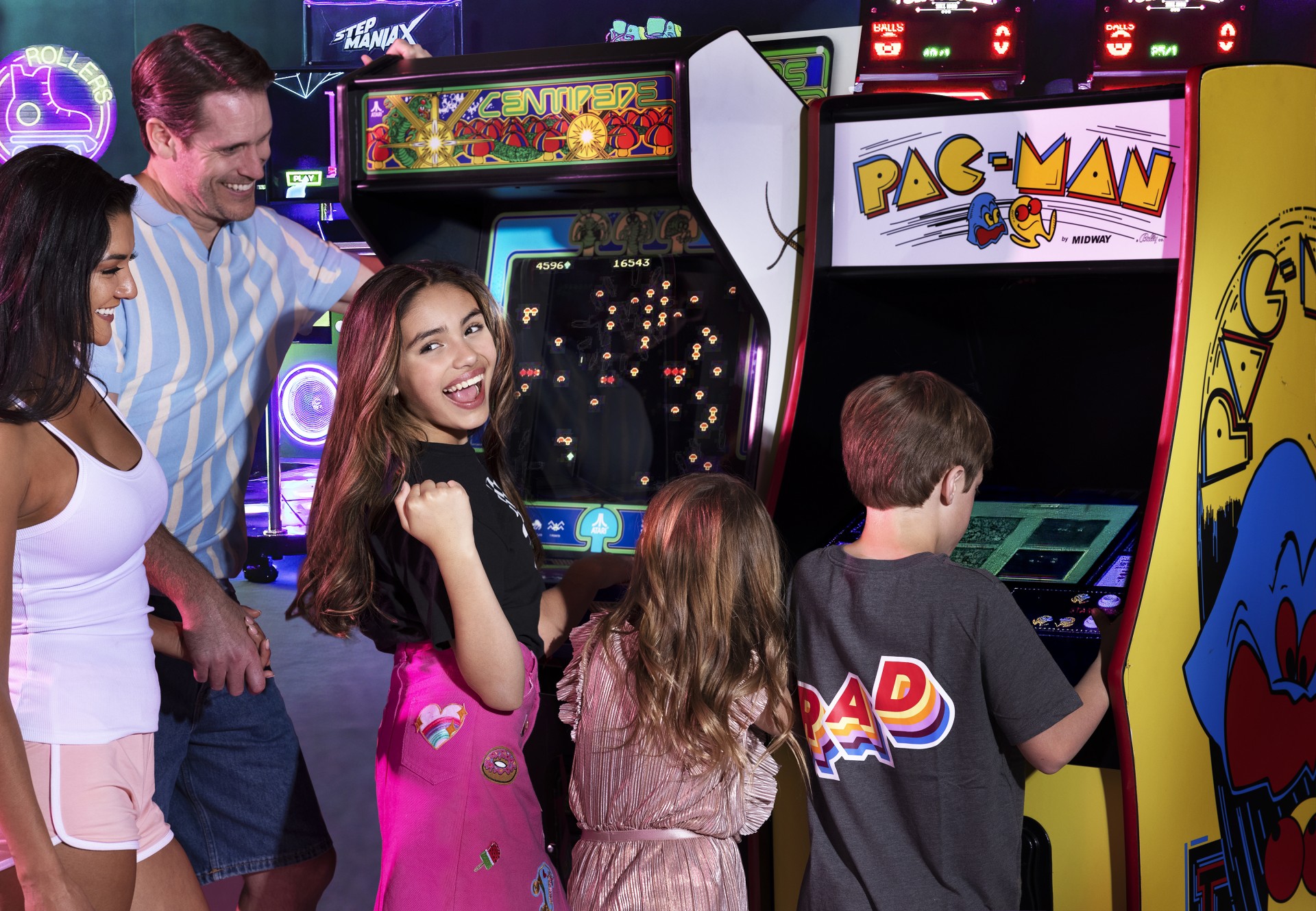 a group of people playing arcade games