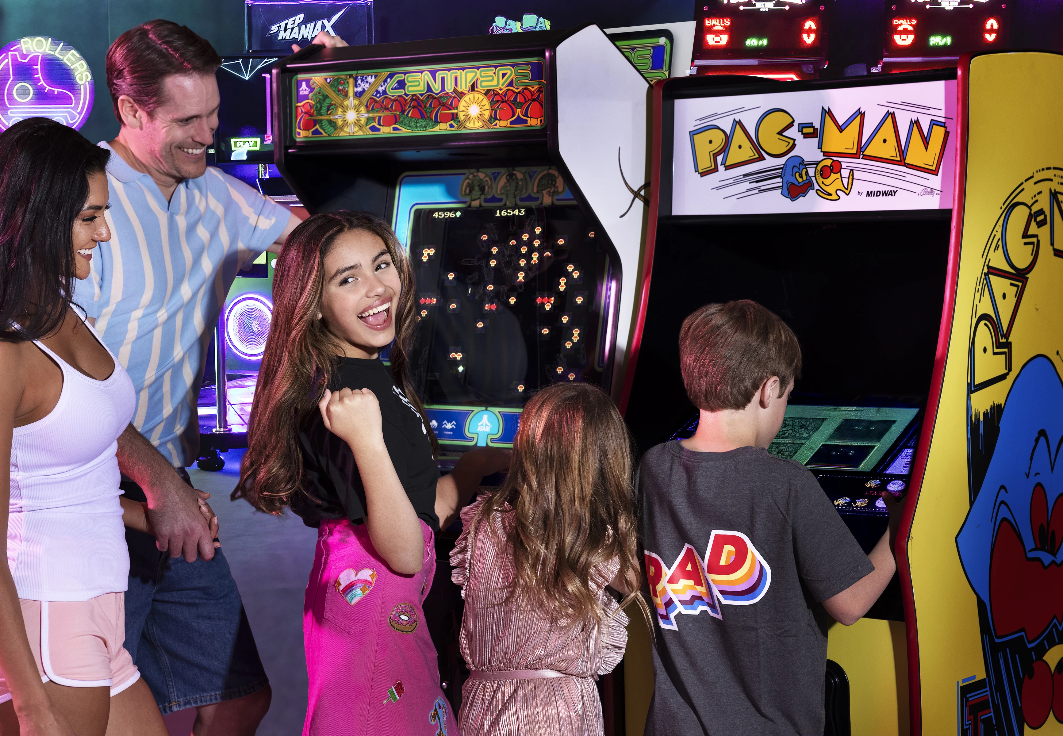 a group of people playing arcade games