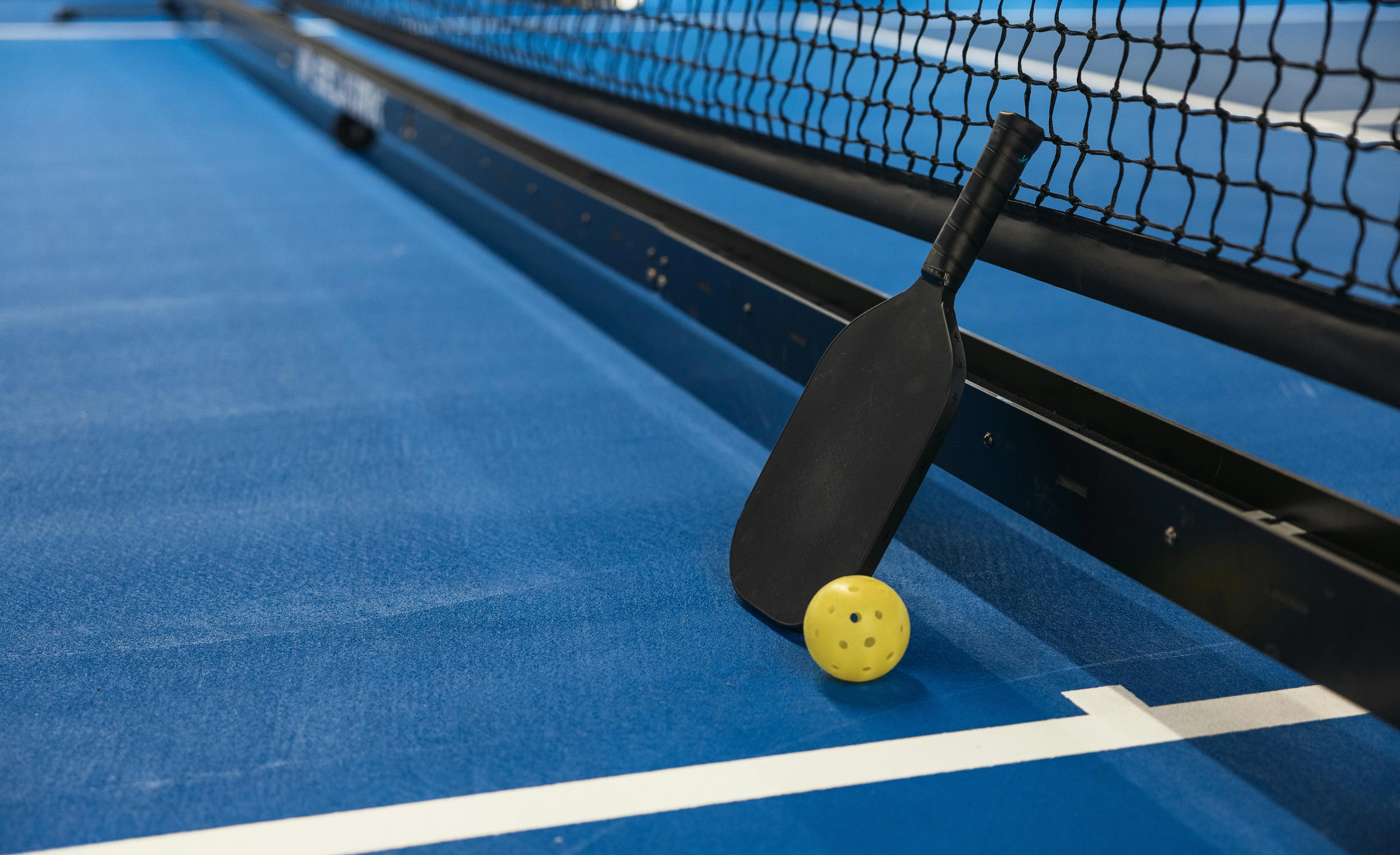 a paddle and ball on a tennis court