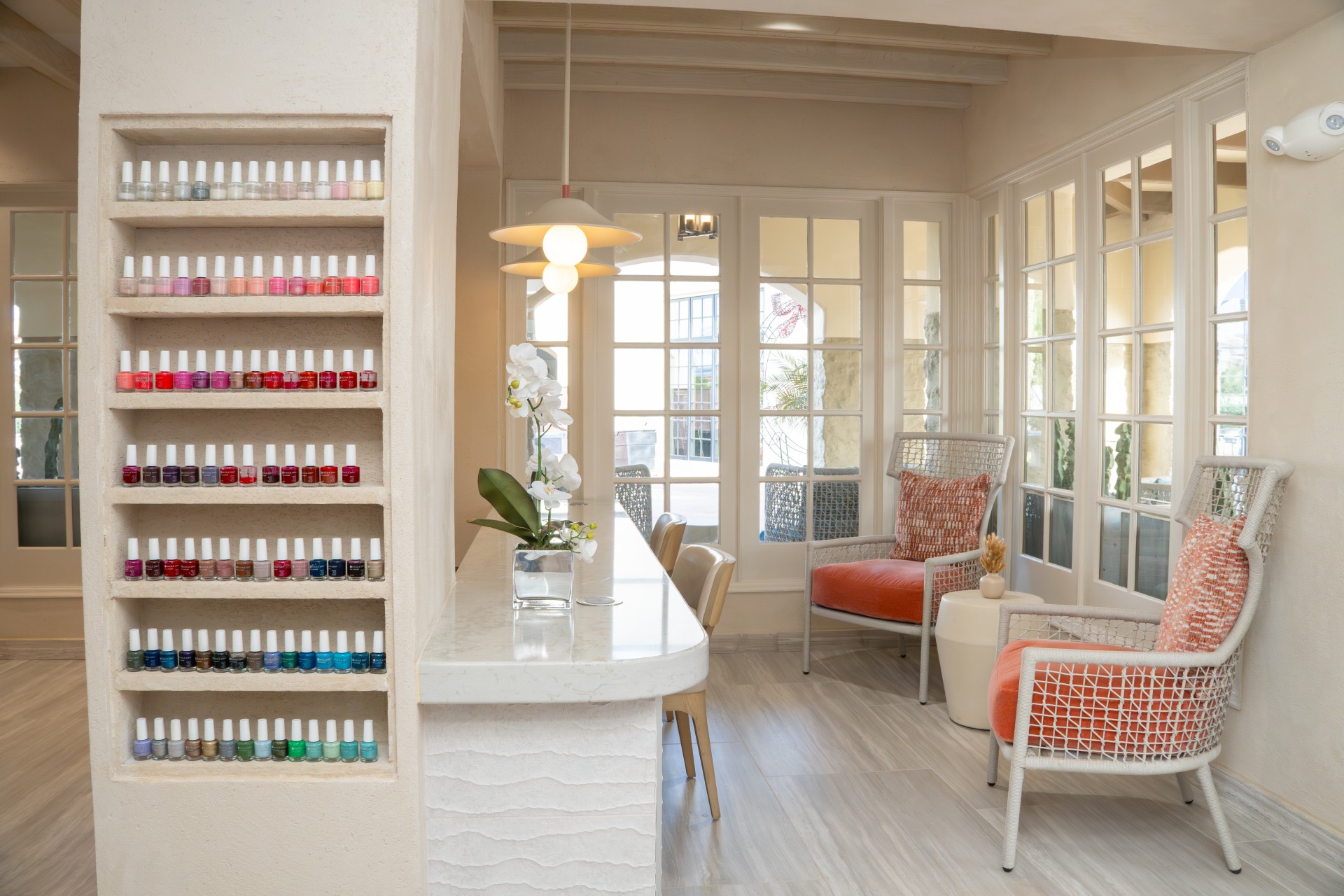 a room with a table and chairs and a table with nail polish