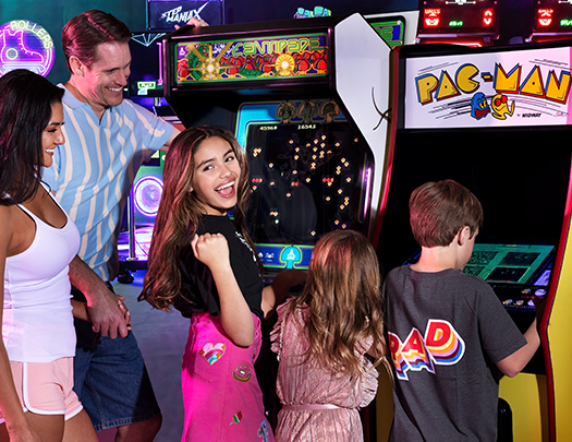a group of people playing arcade games