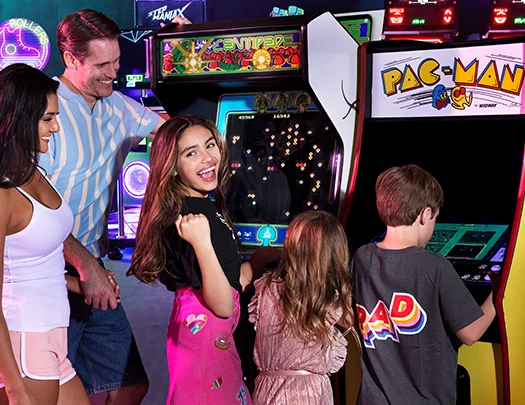 a group of people playing arcade games