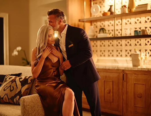 a man kissing a woman on a couch