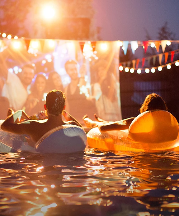 people floating on inner tubes in a pool