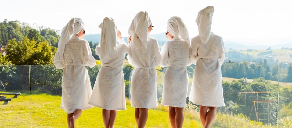 a group of women wearing white robes