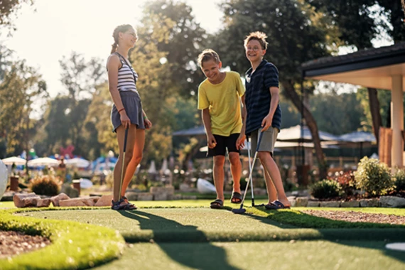 a group of people playing mini golf