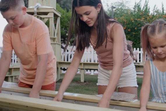 a woman in a striped shirt and white shorts