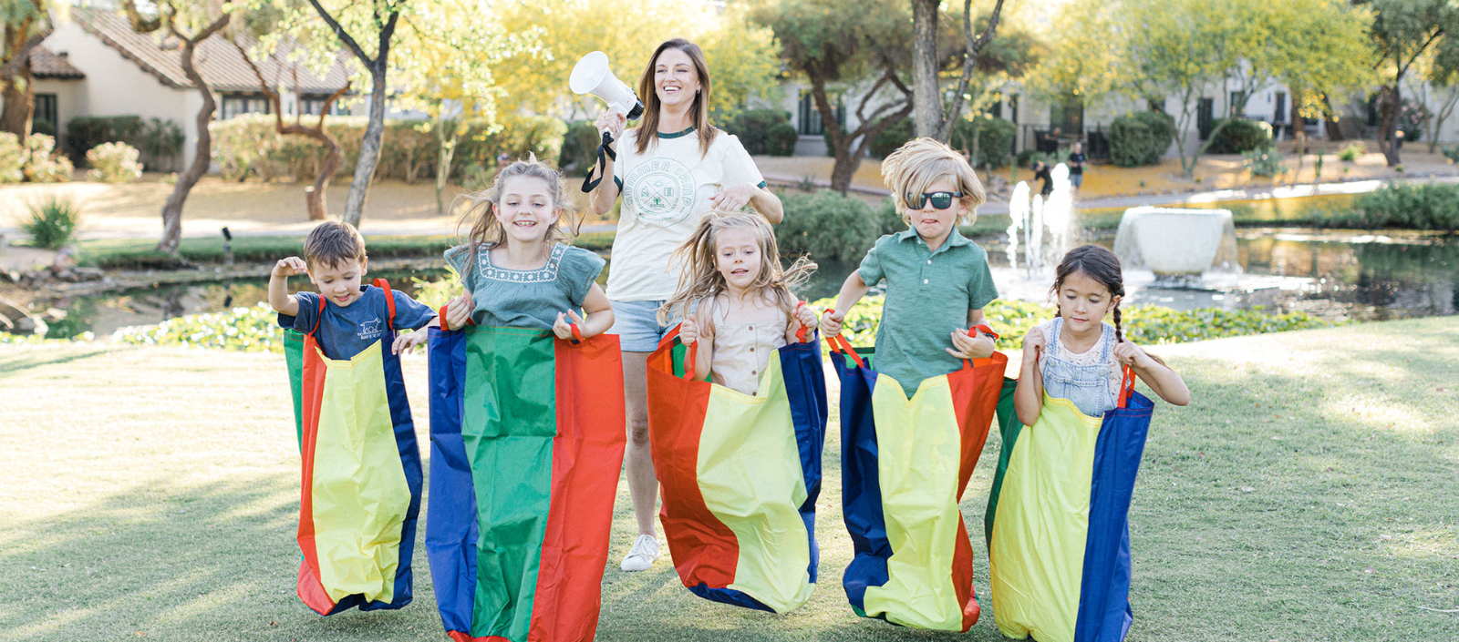 a group of children running in sacks