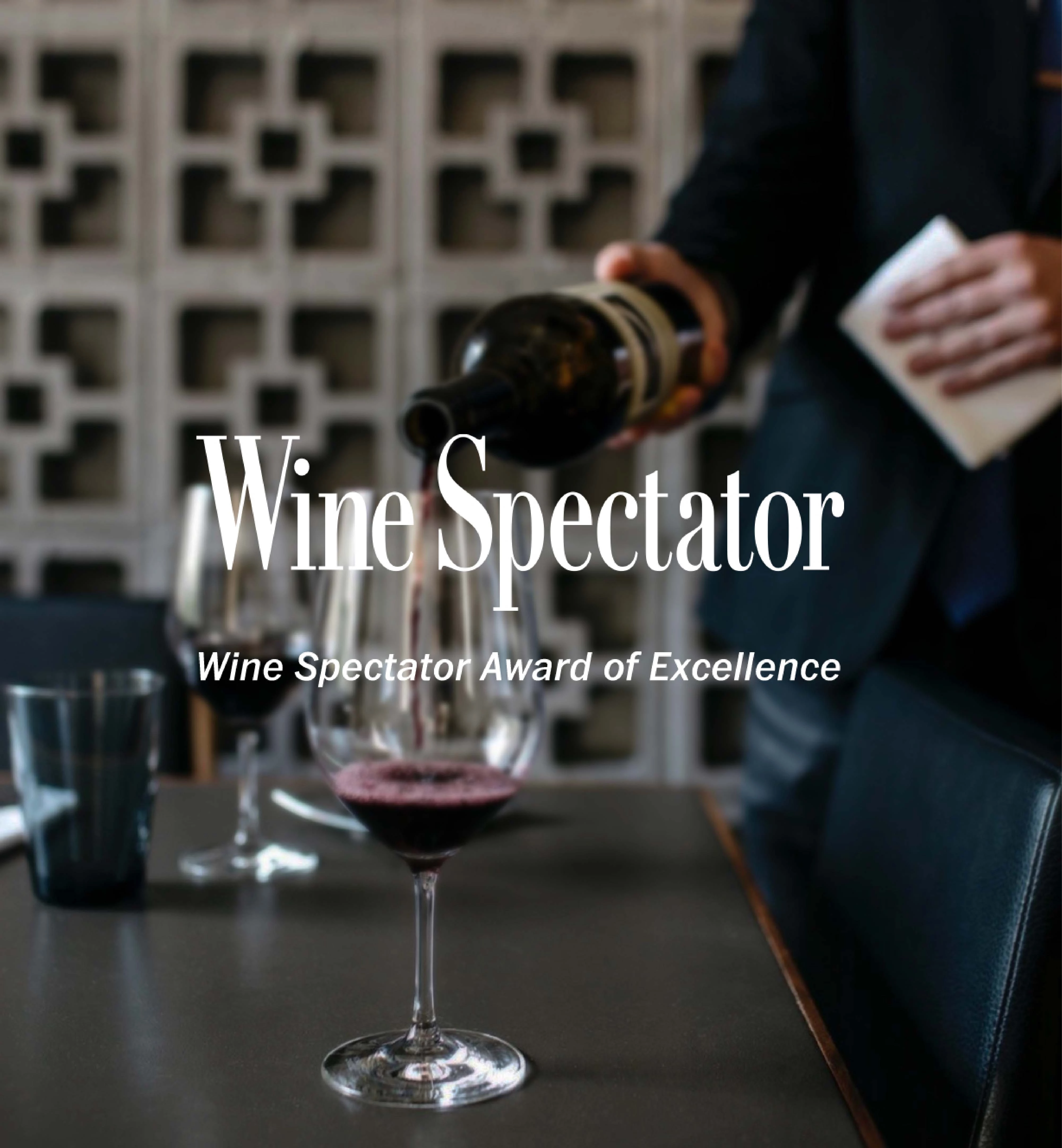 a person pouring a glass of wine