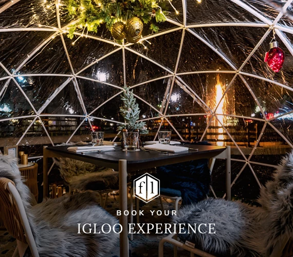 Decorated igloo dinning with Fall Lines logo and book your igloo experience 